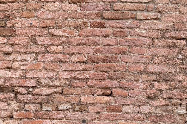 Stucco on the brick wall in Italy. Wall texture background.