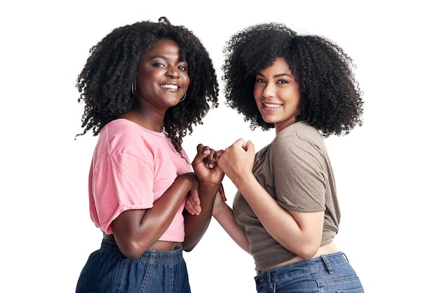 Photo stuck together like glue just me and you studio shot of two young women linking their fingers against a white background