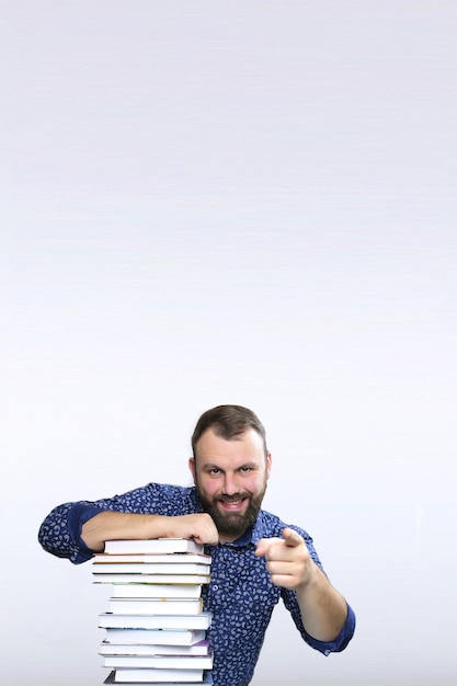 Student adult beard man with stack of book in a library isolated background