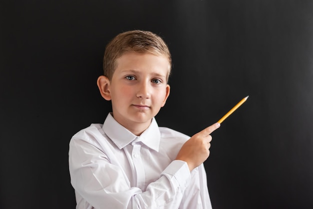 Student child teen at the blackboard with a book