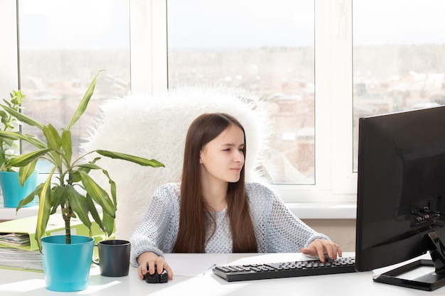 A student on distance learning at home is engaged in online passes tests session