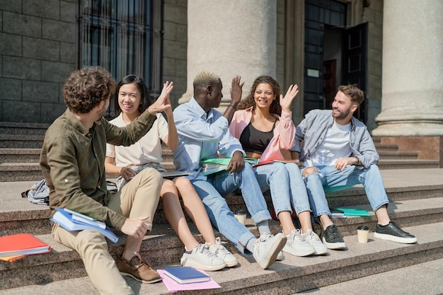 Student friends giving each other a high five