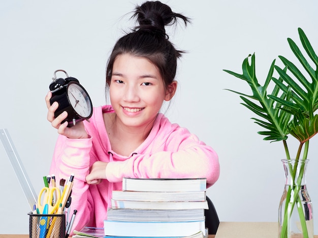 Student girl smiling sitting at desk.