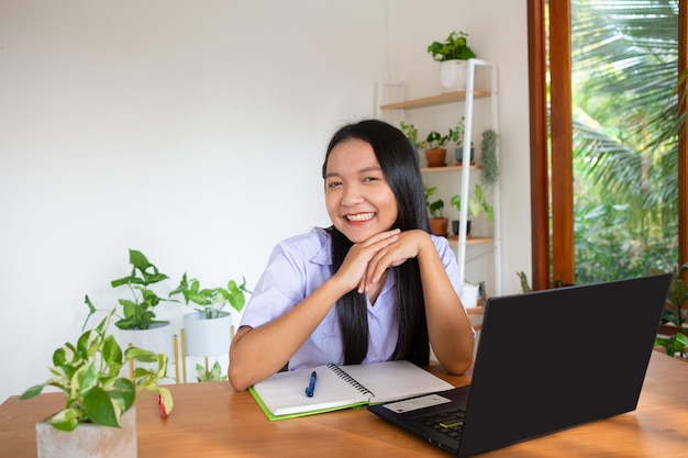 Student girl study by slfe on laptop in room