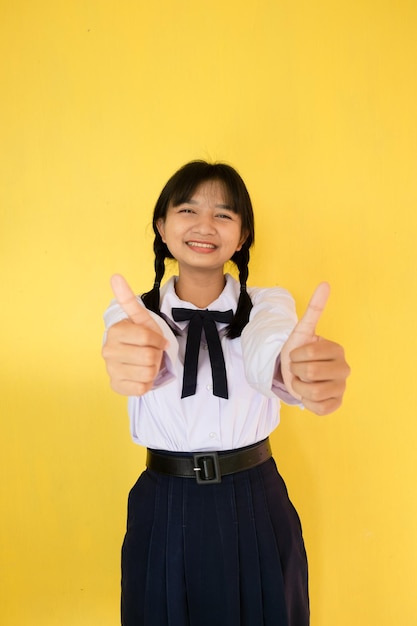 Student girl in uniform on yellow background