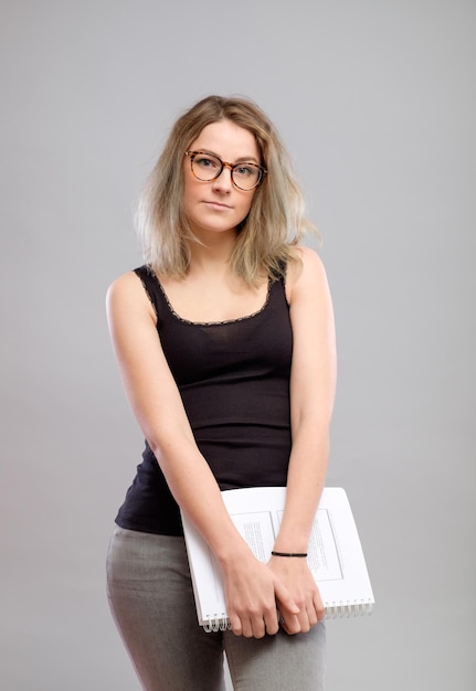 Student girl with glasses holding a book