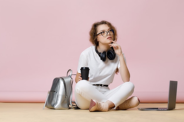 Student girl with laptop backpack and coffee