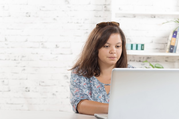 A student girl  working in his office with his computer