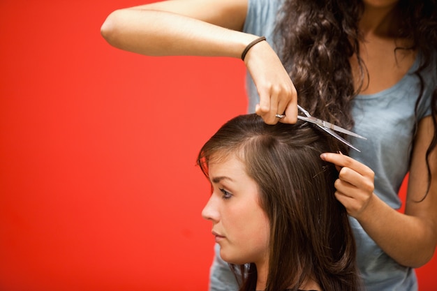 Student hairdresser cutting hair