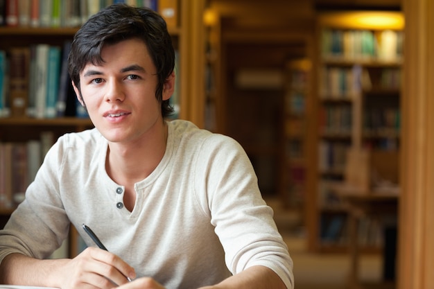 Student holding a pen