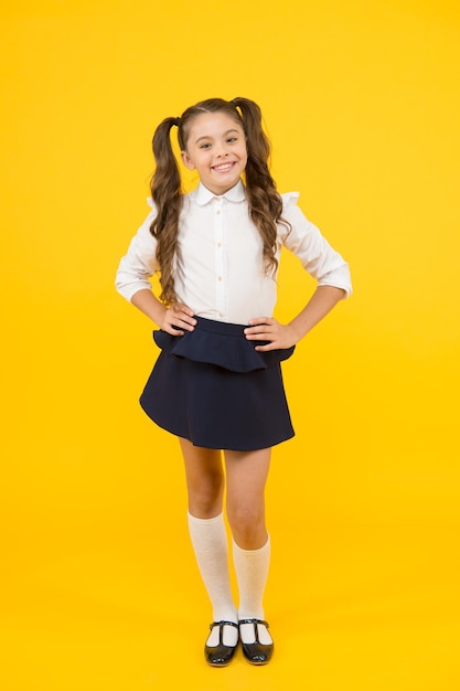 Student little kid emotional school girl successful graduation happy childrens day positive vibes school life concept celebrate knowledge day girl pupil on yellow background back to school