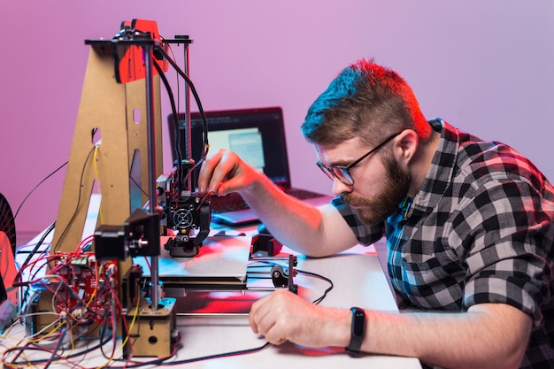 A student man print prototype on printer.