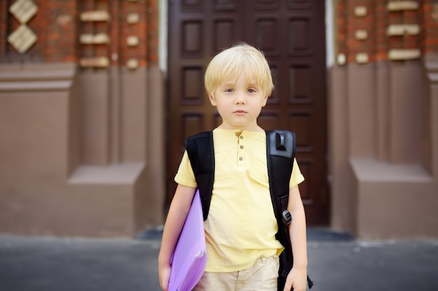 Student near the gate of the school building