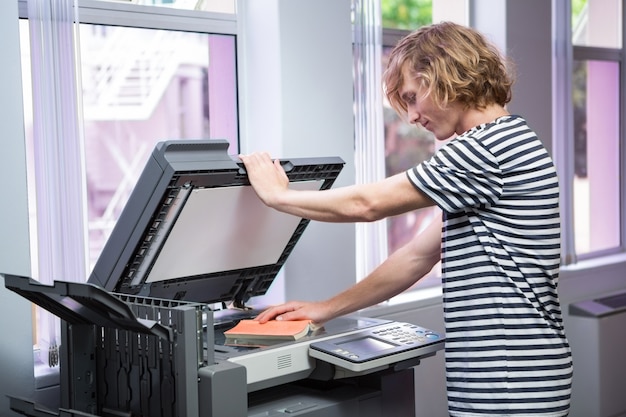 Student photocopying his book in the library