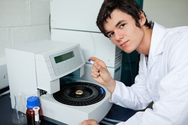 Student posing with a centrifuge