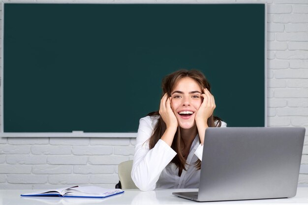 Student preparing exam and learning lessons in school classroom Portrait of happy female university student study lesson at school or university