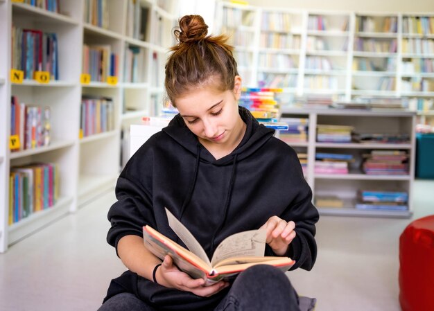 Student reading book in library