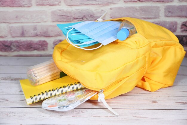 Photo student school bag pack with sanitizer, a face mask.