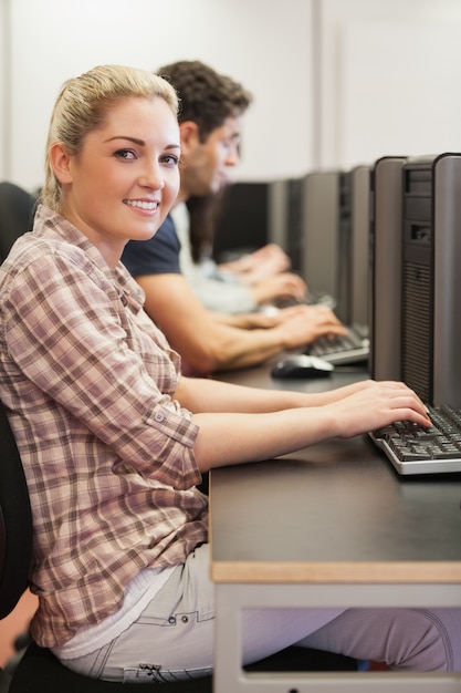 Student sitting at desk typing 