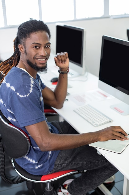 Student smiling at camera in computer class