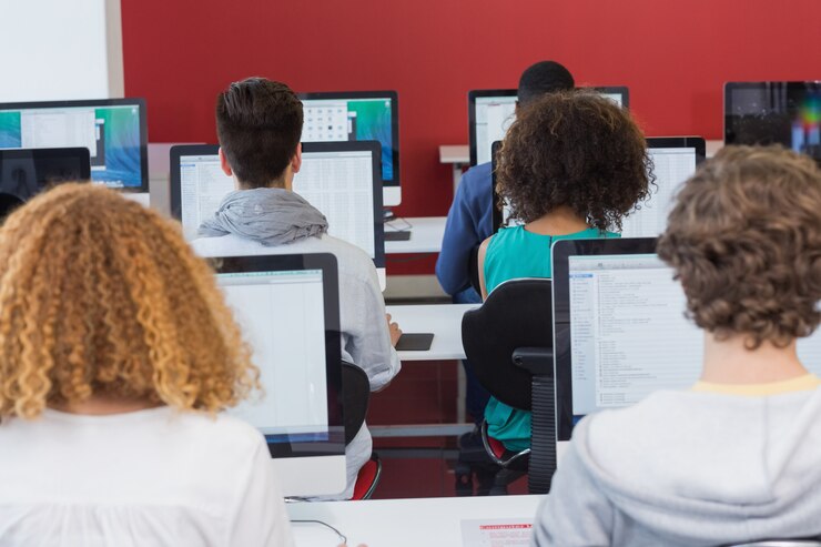 Photo student smiling at camera in computer class