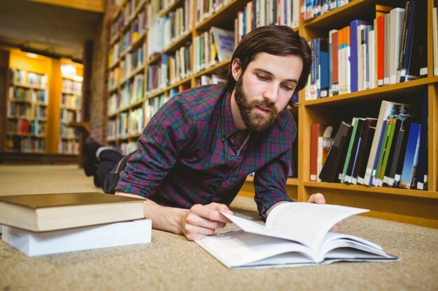 Student studying on floor in the library