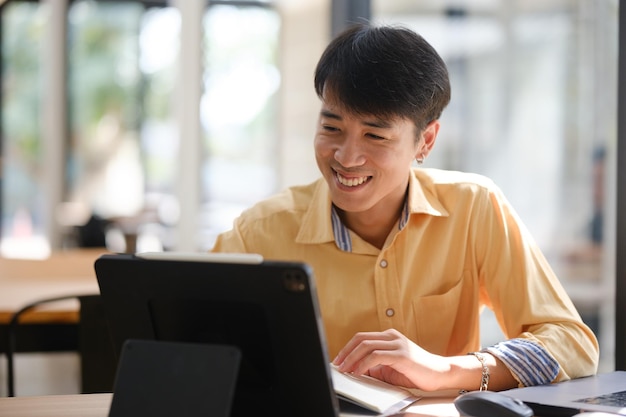 student studying online and preparing for exams with digital devices and books