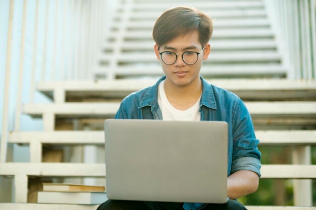 Student studying outdoor using laptop