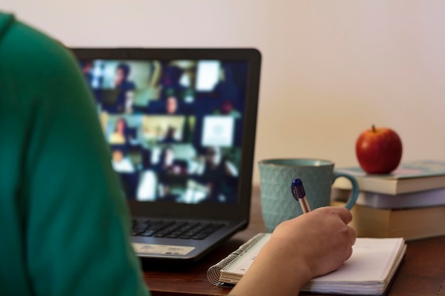 Photo student taking notes at online class concept of e-learning