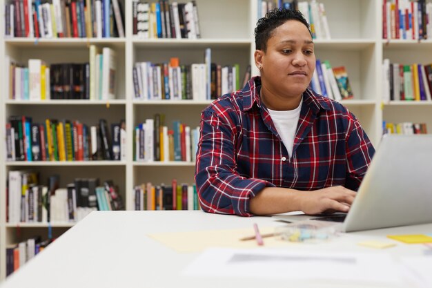 Student using Laptop in Library