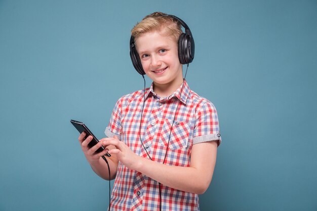 Student with headphones looking at mobile phone display