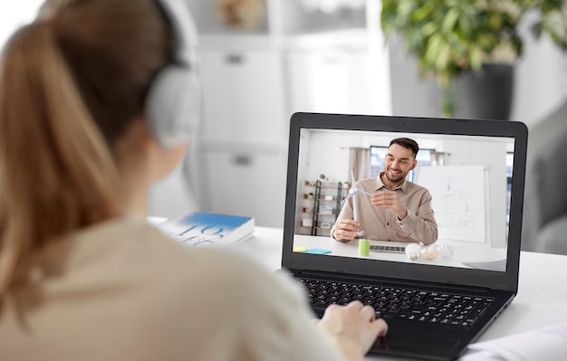 student with laptop having online class at home