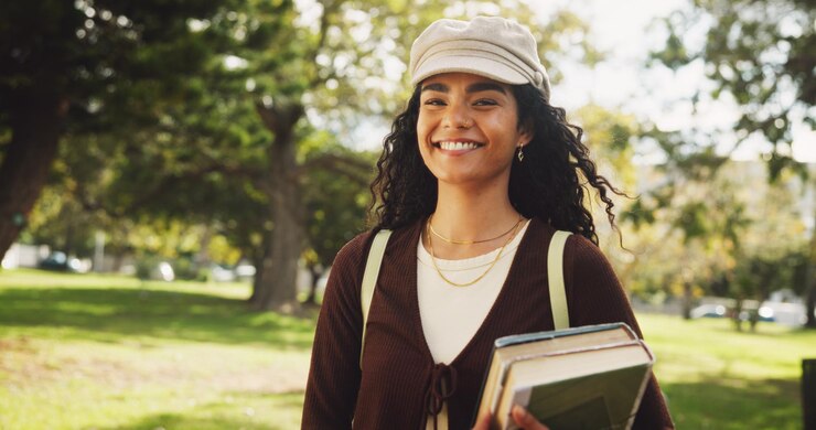 Photo student woman and outdoor in portrait books and walk to class for education learning and development at campus person smile and park with backpack for scholarship at university in brazil