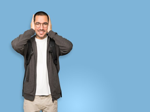 Student worried about loud noises and covering his ears