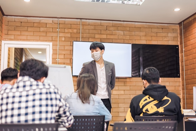 Students are taking exams to collect grades at the end of the semester And there is a young teacher supervising the exams in the classroom.