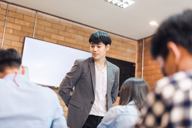 Students are taking exams to collect grades at the end of the
semester and there is a young teacher supervising the exams in the
classroom.