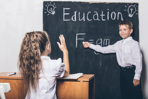 Students in the class at the Desk against the slate