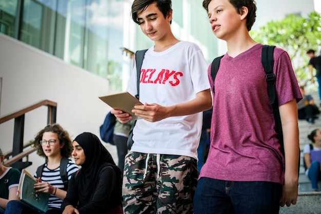 Students friends relax talking on staircase