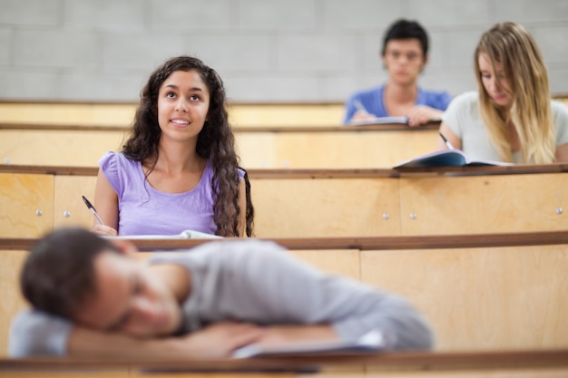 Foto gli studenti ascoltano mentre il loro compagno di classe sta dormendo