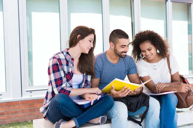 Students sharing notes in the university campus