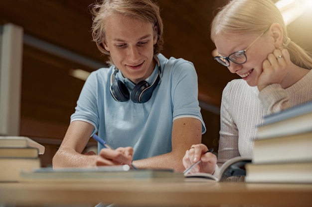 Students sit in the library and take notes while preparing for the exam