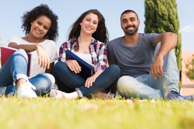 Students sitting on the grass at School Campus