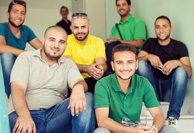 Photo students sitting on stairs indoors