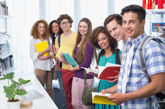 Students smiling at camera standing in a line 