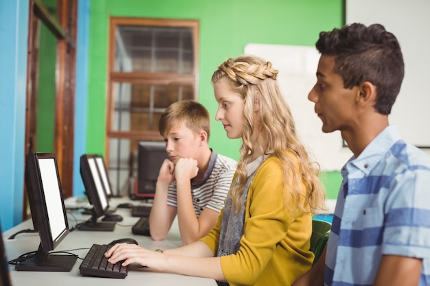 Students studying in computer classroom