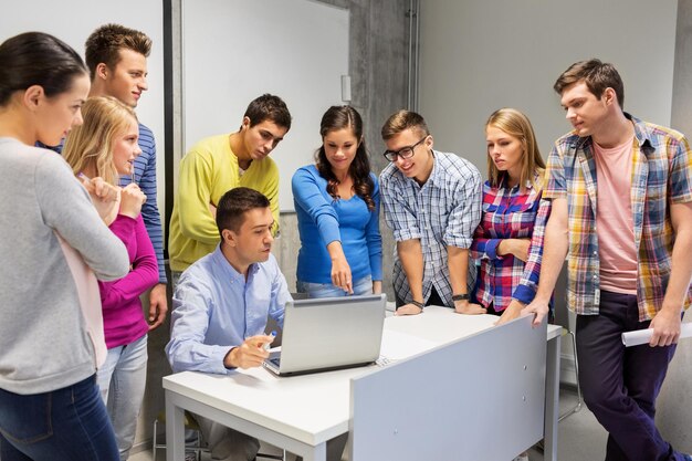 Photo students and teacher with laptop at school