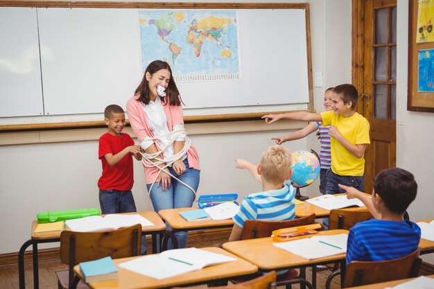 Students tying the teacher up