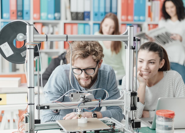 Students using a 3D printer