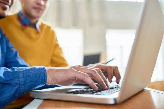 Students Using Laptop Close Up