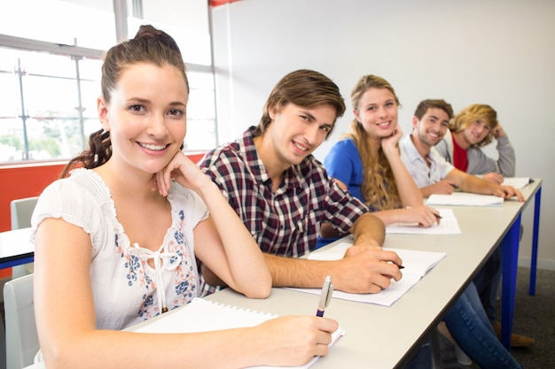 Students writing notes in classroom